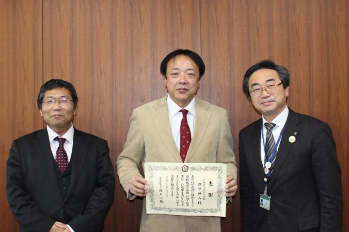 藤原伸二教諭が兵庫県優秀教職員表彰の表彰状をカメラに向けている写真